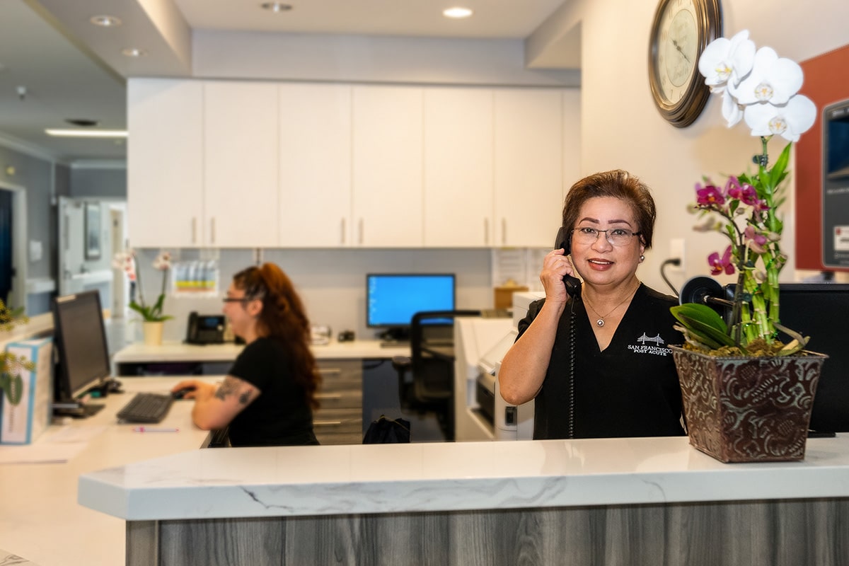 smiling nurses at a nurses station